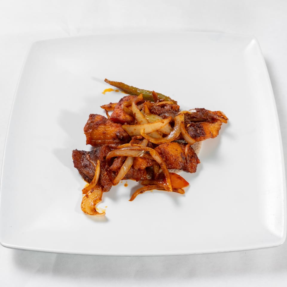Fish dulet served with onions and peppers.