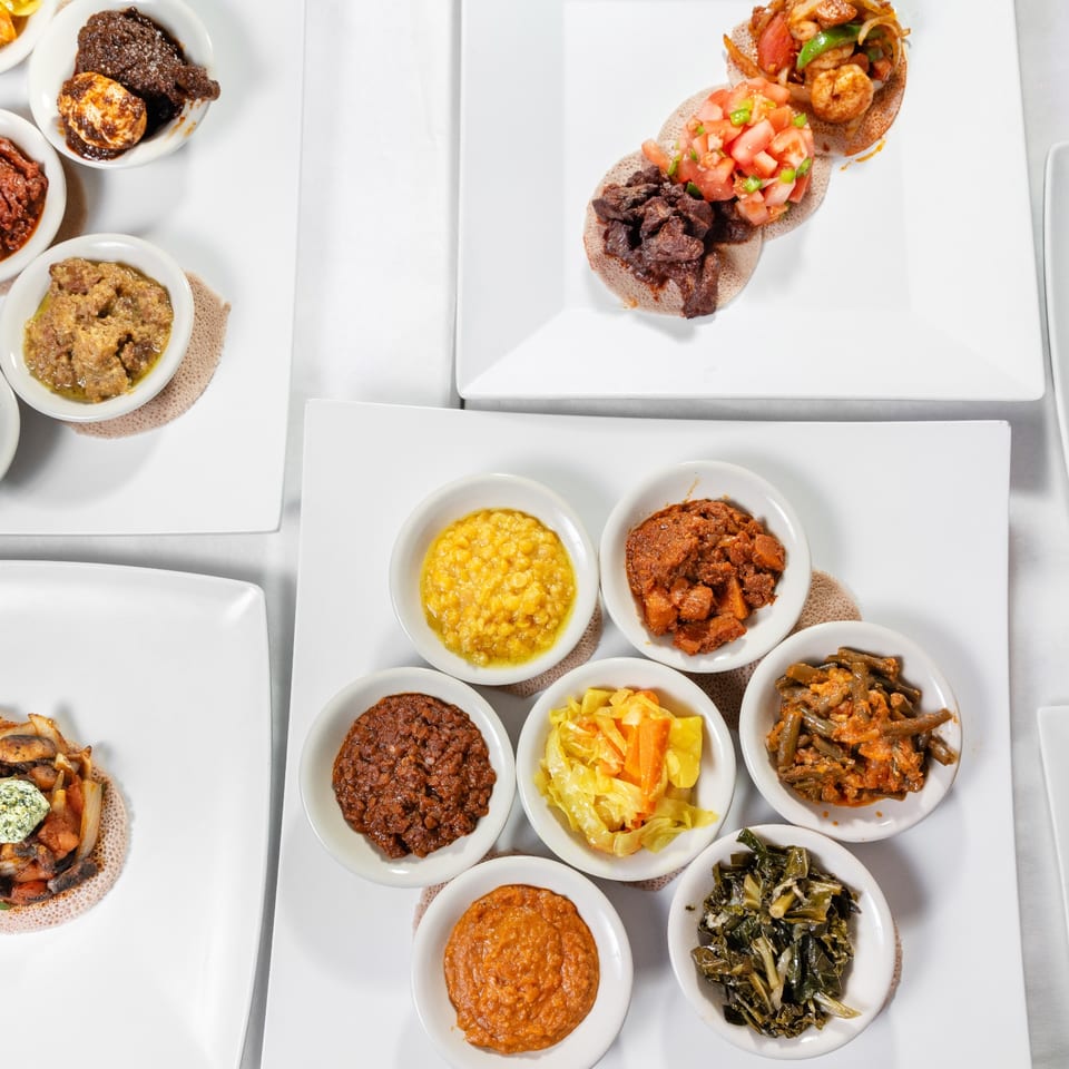 Ethiopian dishes arranged on injera.