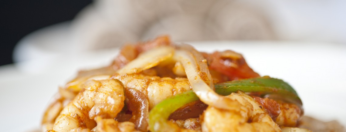 A plate of stir-fried chicken with vegetables.