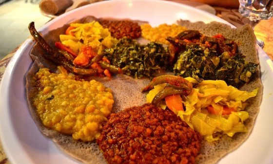 A traditional Ethiopian food platter with various stews.