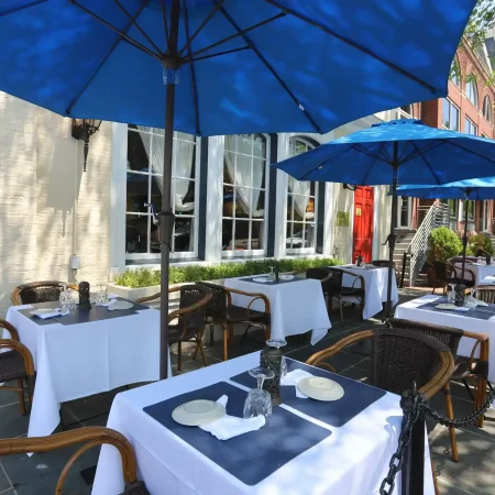 Outdoor restaurant seating with blue umbrellas.